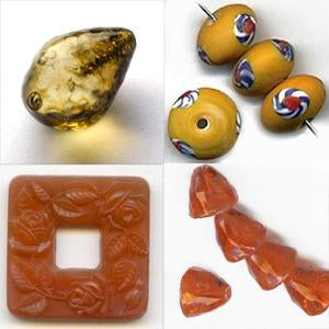 Selection of yellow and orange glass beads, tortise drop, mustard eye, orange cones, salmon glass pendant