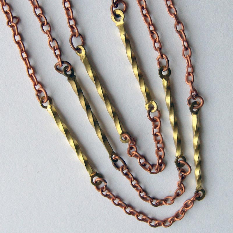 Vintage copper over steel 2 mm cable chain with brass twist links. Sold by the foot.