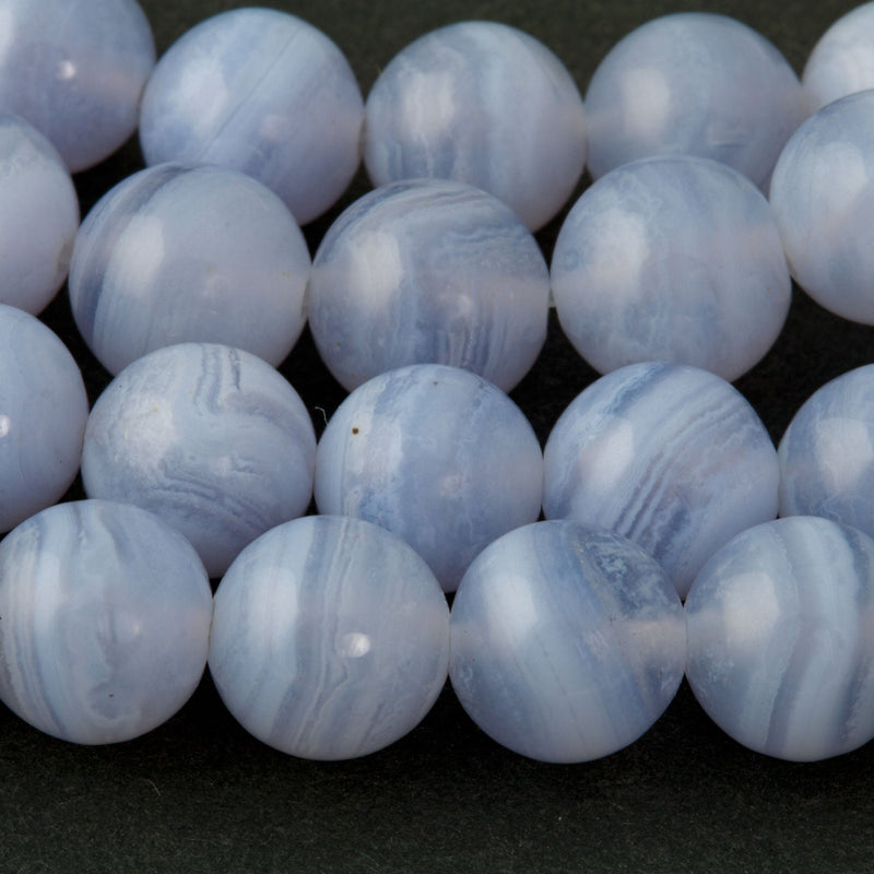 AA  natural blue lace agate beads. 8mm.Good polish and evenly drilled.  Old high quality stock from the 1980s.  Sold loose.  25 beads.  Approximate equivalent to an 8 inch strand.