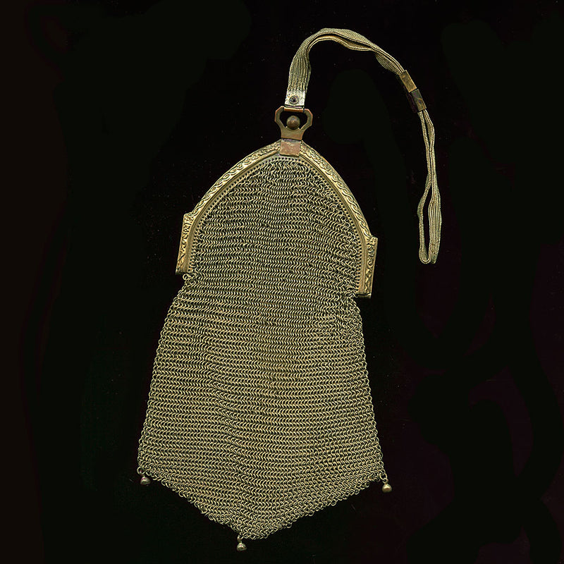 1920s gold mesh dance bag with cathedral frame and scalloped bottom.