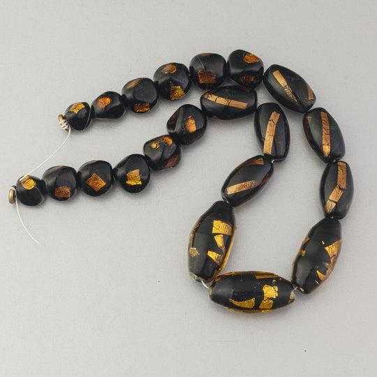 Vintage Venetian 12 inch graduated strand of black and gold foil beads.  b1-3022