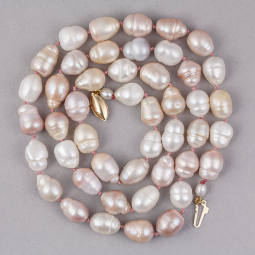 Pearl necklace with gold clasp on a gray background