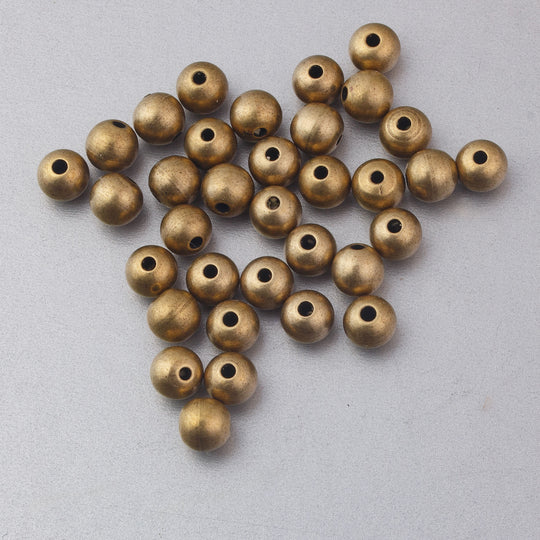 Vintage solid brass round beads.Rich patina. 5.25 mm. Pkg. 12.  b18-696