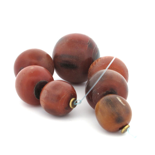Vintage horn trade beads from West Africa.  Graduated strand of 7.  18-33mm. b3-ho28c