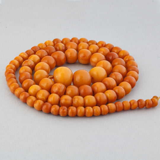 22.5" graduated strand of 88 butterscotch egg yolk natural amber beads. b4-amb149