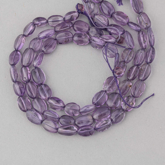 Vintage A grade amethyst oval beads.  9x6x4mm. 8 inch strand. b4-ame245