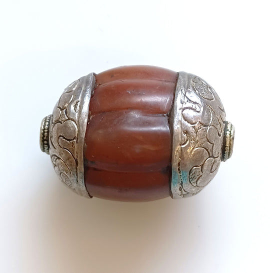 Antique Tibetan large carved carnelian melon bead with sterling silver repoussé caps. 37x25mm  B4-car361