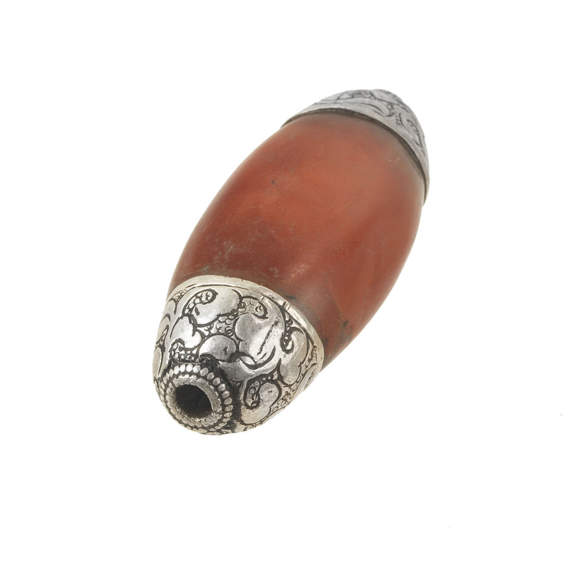 Nepali carved carnelian agate oval bead with repousse sterling silver caps. b4-car399