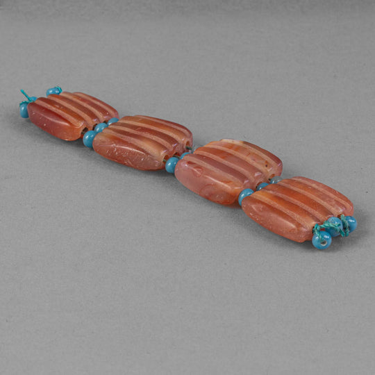 Old carnelian carved 3-strand tablet shaped beads.21-23mm length. Nepal. Strand of 4. b4-car429