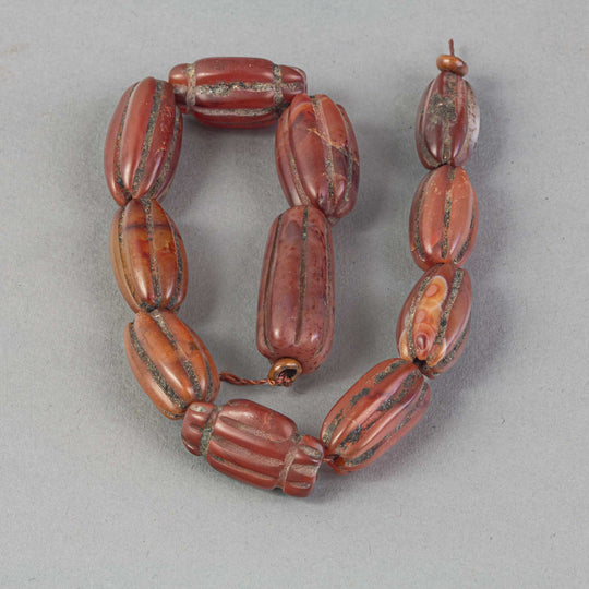 Old opaque carnelian carved oblong beads.  Strand of 11.  Nepal.  B4-car426