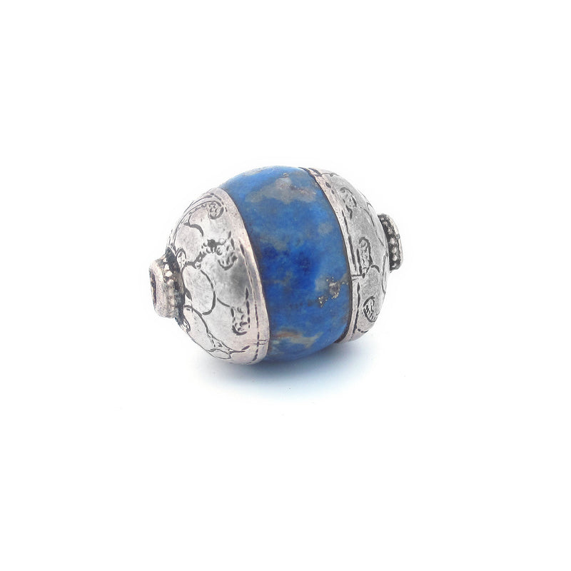 Antique Tibetan carved lapis bead with repousse sterling silver caps. Average 23x17mm. b4-lap294