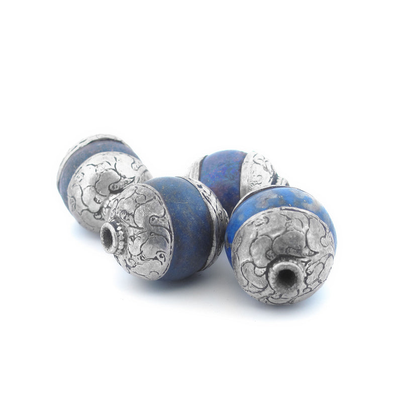 Antique Tibetan carved lapis bead with repousse sterling silver caps. Average 23x17mm. b4-lap294