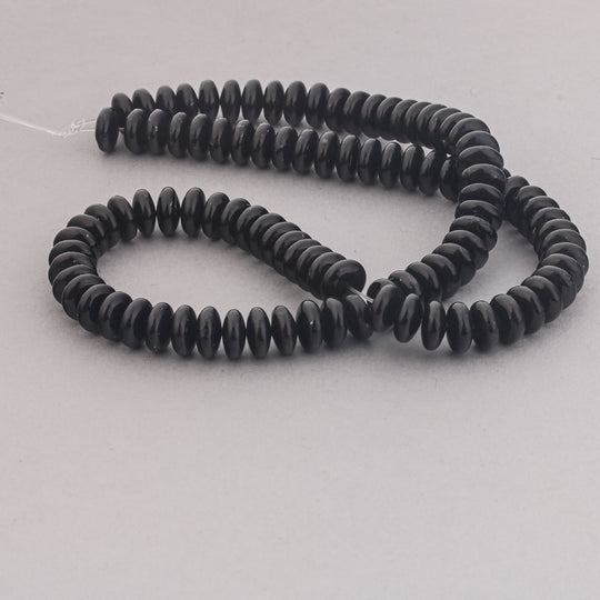 Black onyx saucer beads 4x8mm. 16 inch strand. Vintage A quality 1980s. b4-ony302