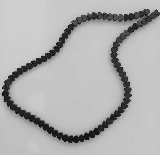Vintage carved  flat black onyx heart beads.  7x6mm.  16 inch strand. b4-ony315
