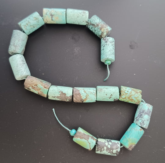 Old stock natural Hubei Turquoise 10x16mm light blue with dark matrix tube beads.  10" strand. b4-tur502