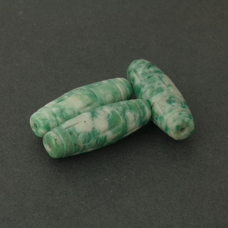 Carved opaque light green and white serpentine cylinder bead. 30x10mm. Sold individually. b4-ser513
