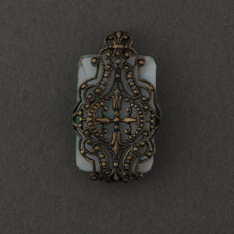 1920s Czechoslovakia pressed Jade glass and brass filigree pendant. 25x16mm.  b5-562pd