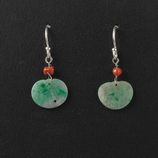 Earrings of antique carved green jade ornaments and deep salmon coral beads. erja888