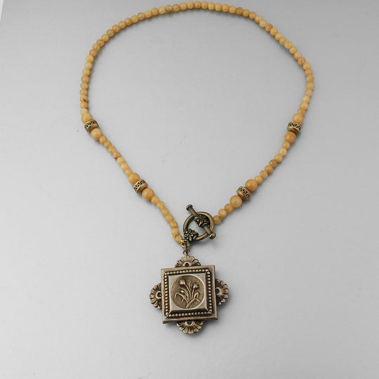 Victorian brass fob necklace strung with vintage Japanese mustard yellow glass and brass accent beads. 16.25 inches.  .  NLBD2254