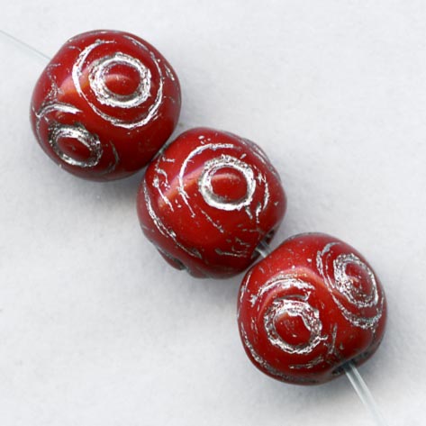 Pressed cherry red glass beads with silver décor 7mm. Pkg of 20.