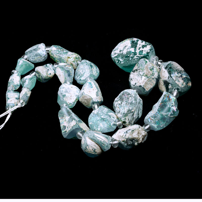 16 inch strand of excavated and reworked ancient glass beads with high rainbow burial patina.