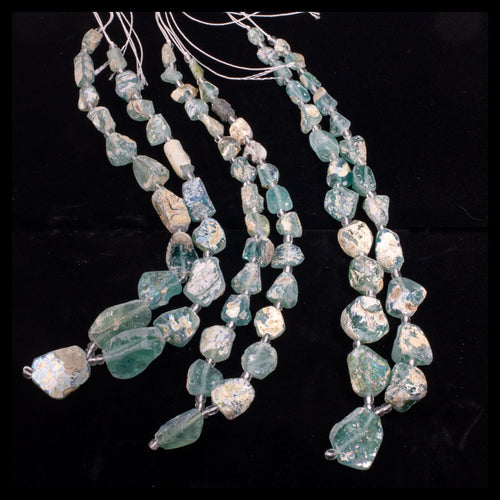 16 inch strand of excavated and reworked ancient glass beads with high rainbow burial patina.