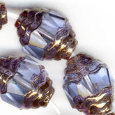 Faceted light sapphire oval with bronzed edges. 8x10mm. Pkg of 4.