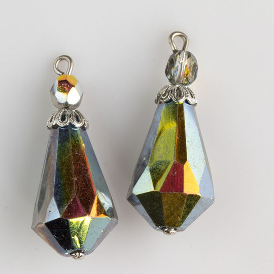 Two bead crystal AB teardrop w/ silver color bead cap. Teardrop measures 21x13mm, top bead measures 5mm. Measures 30mm long. Pkg. of 2. b11-cr-0918