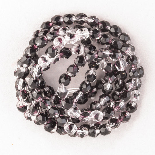 Czech firepolished faceted 6mm clear glass beads with dark amethyst  tortoise markings. 30"strand.. b11-cr-0929