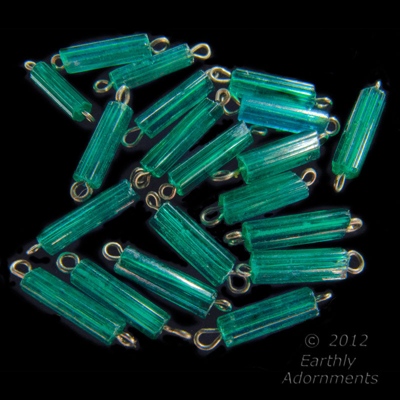 Vintage translucent emerald glass bugles on fine wire. 6 sided. 9x2mm. Package of 50.