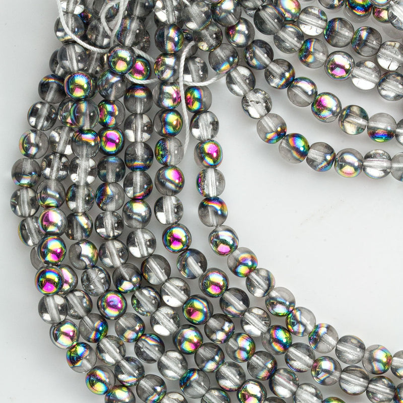 Contemporary Czech clear glass beads with a 1/2 vitrail finish.6mm,12" strand, or 50 beads