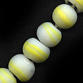 Old Czech matte glass pale yellow striated irregular rounds. 25x12mm. Pkg of 2