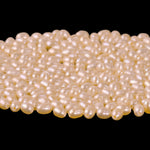 AA quality freshwater pearls, loose, ovals light apricot. 4x3mm. Pkg100. 1990s.