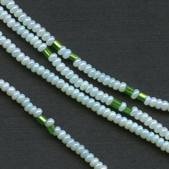 b17-104-Antique Italian pale green 11/0 seed beads with interspersed emerald green foil lined. 8 grams