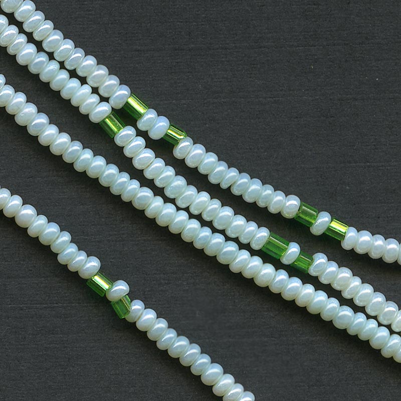 Antique Italian pale green 11/0 seed beads with interspersed emerald green foil lined. 8 grams