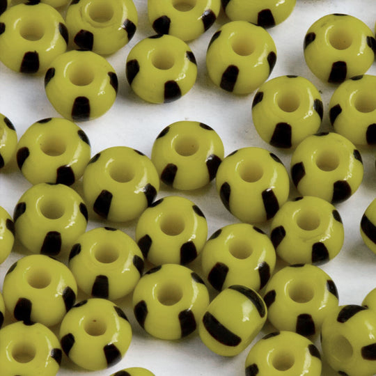 Vintage yellow with black stripe bumblebee rocailles. Size 6. 15 gram pack. b17-157