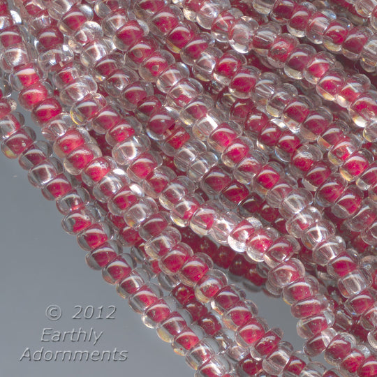 Vintage Clear glass rocailles with red foil core seed bead.  Size 12/0. 36 gram hank. b17-232