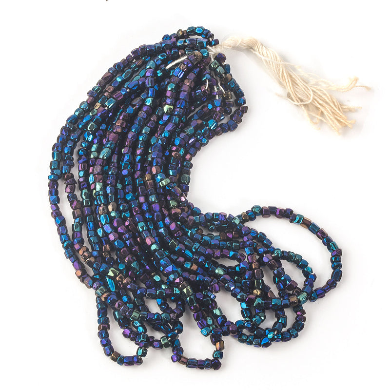 Antique blue iris tri-cut seed beads. 10/0 to 11/0. Early 1900s. 8.6 gram hank. 
