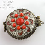 Silver on copper lacey filigree locket with red glass stones.