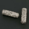 Silver plated hollow cylinder with stamped floral design. 20x6mm with 1mm hole. Sold individually. b18-583
