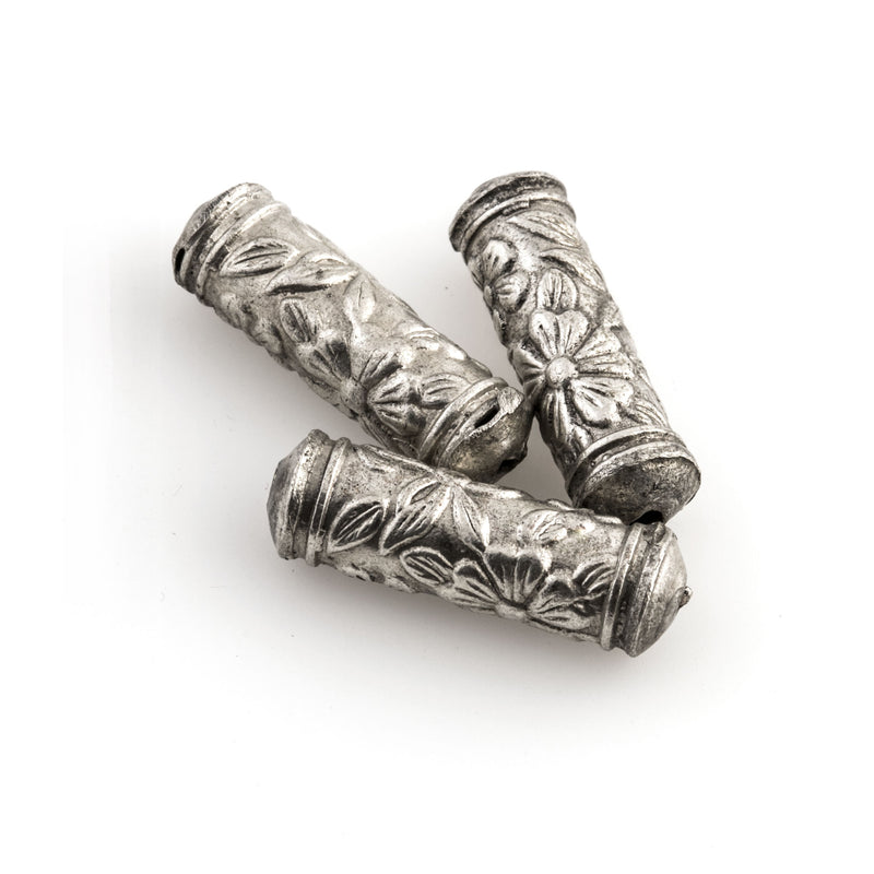 Silver plated hollow cylinder with stamped floral design. 20x6mm with 1mm hole. Sold individually. b18-583
