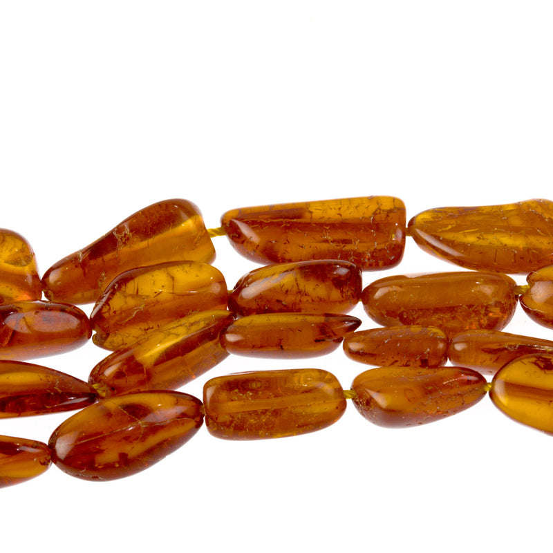 Genuine natural Baltic amber long flat ovals bead strand.  24".  11-17mm.