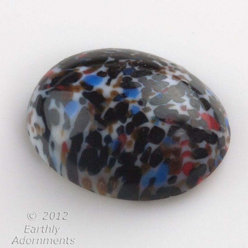 Vintage West German multi-color millefiori on white oval cabochon.