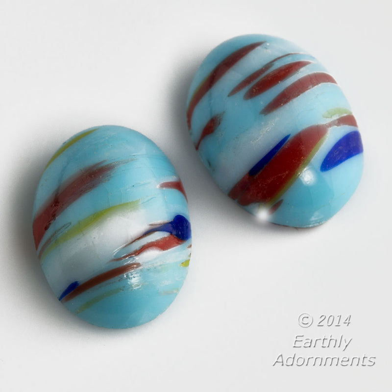 Vintage Japanese glass 18x13mm opaque sky blue cabochon with multi color striations. Sold individually.