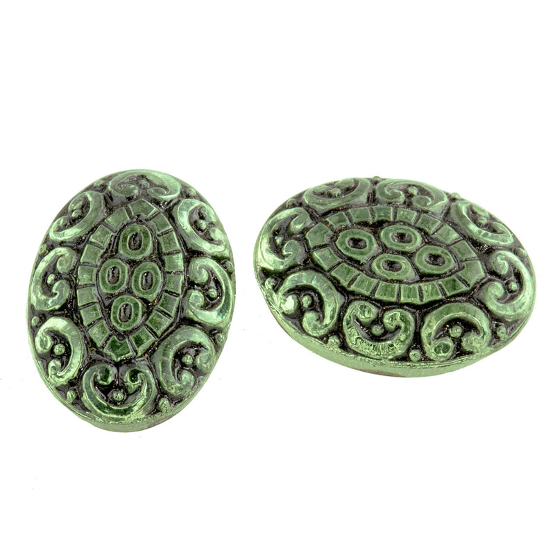 Pressed light green foiled German glass oval cabochon with black enamel. 18x13mm.  Pkg 2.