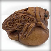 Hand carved boxwood cicada on peach ojime bead. 18x22mm. Pkg. of 1.