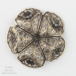 Oxidized brass filigree in a buttercup shape. 45x15mm Sold individually.