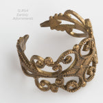 Vintage brass stamped filigree ring shank. 15mm wide the the top. Sold individually. b9-2309(e)