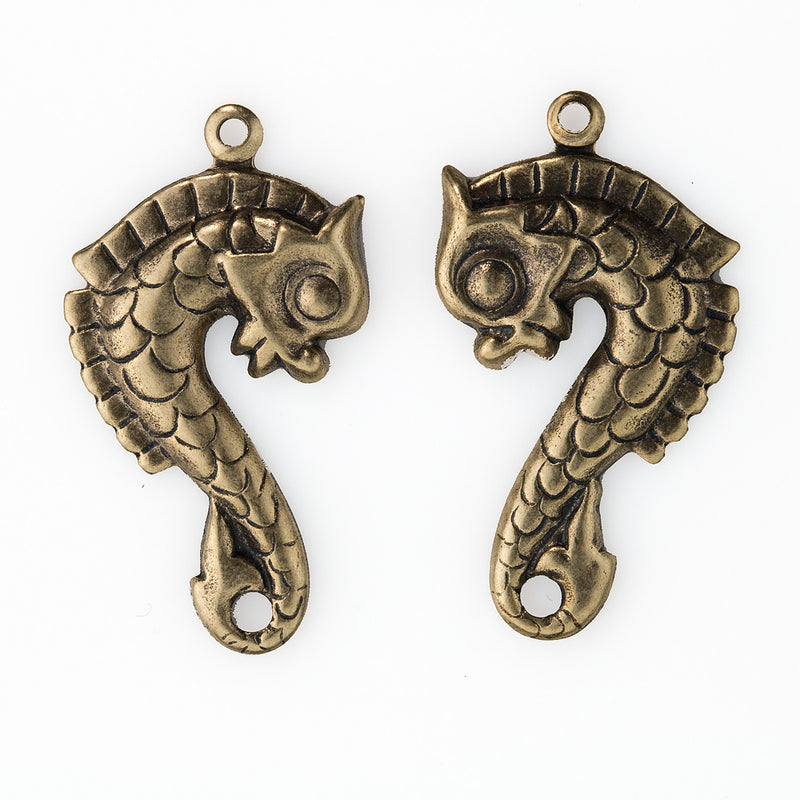 Oxidized brass medieval stamped sea horse charms. 30x16mm. Sold as 1 facing pair.