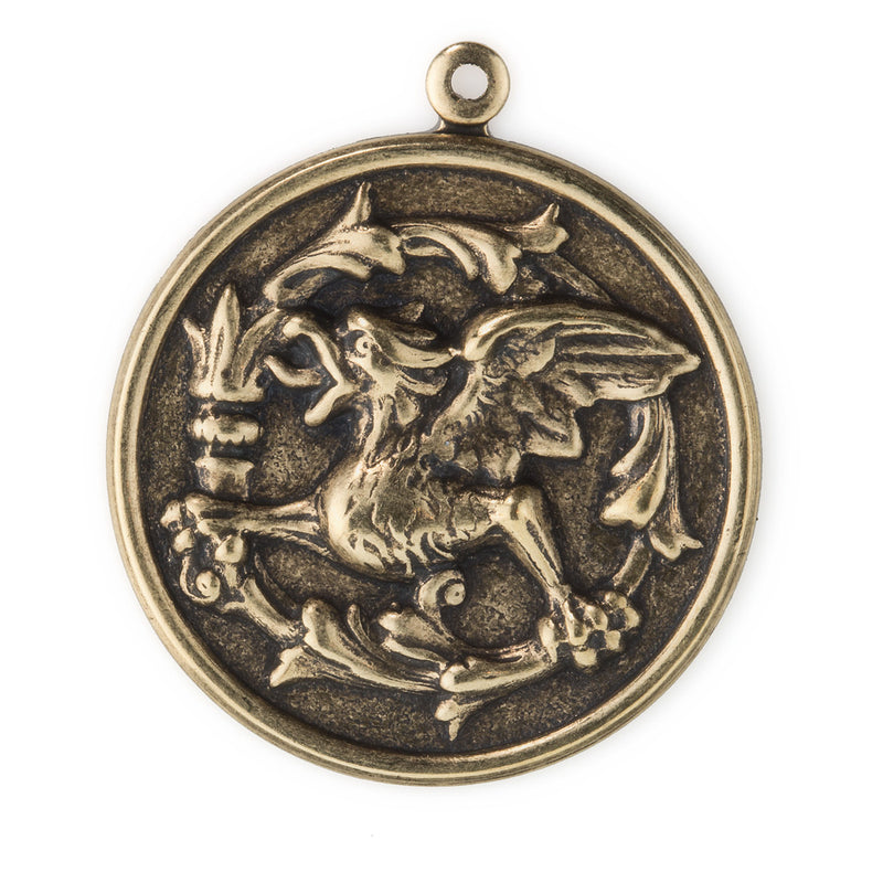 Stamped oxidized brass repousse gryphon coin charm. 33x28mm. Package of 2.